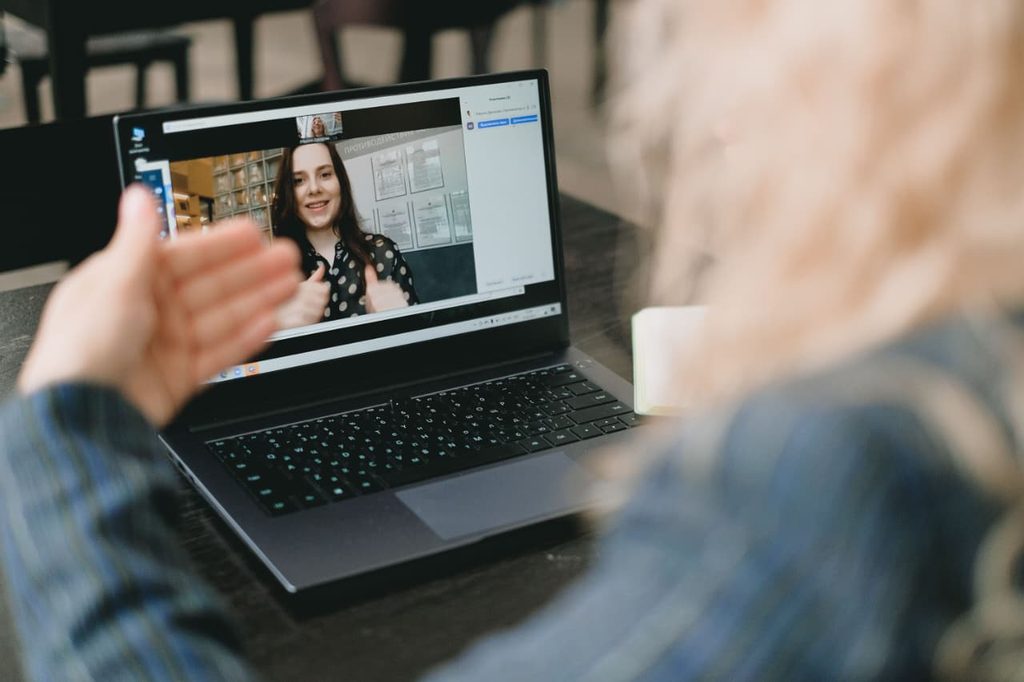 student freelancer communicating with client on laptop